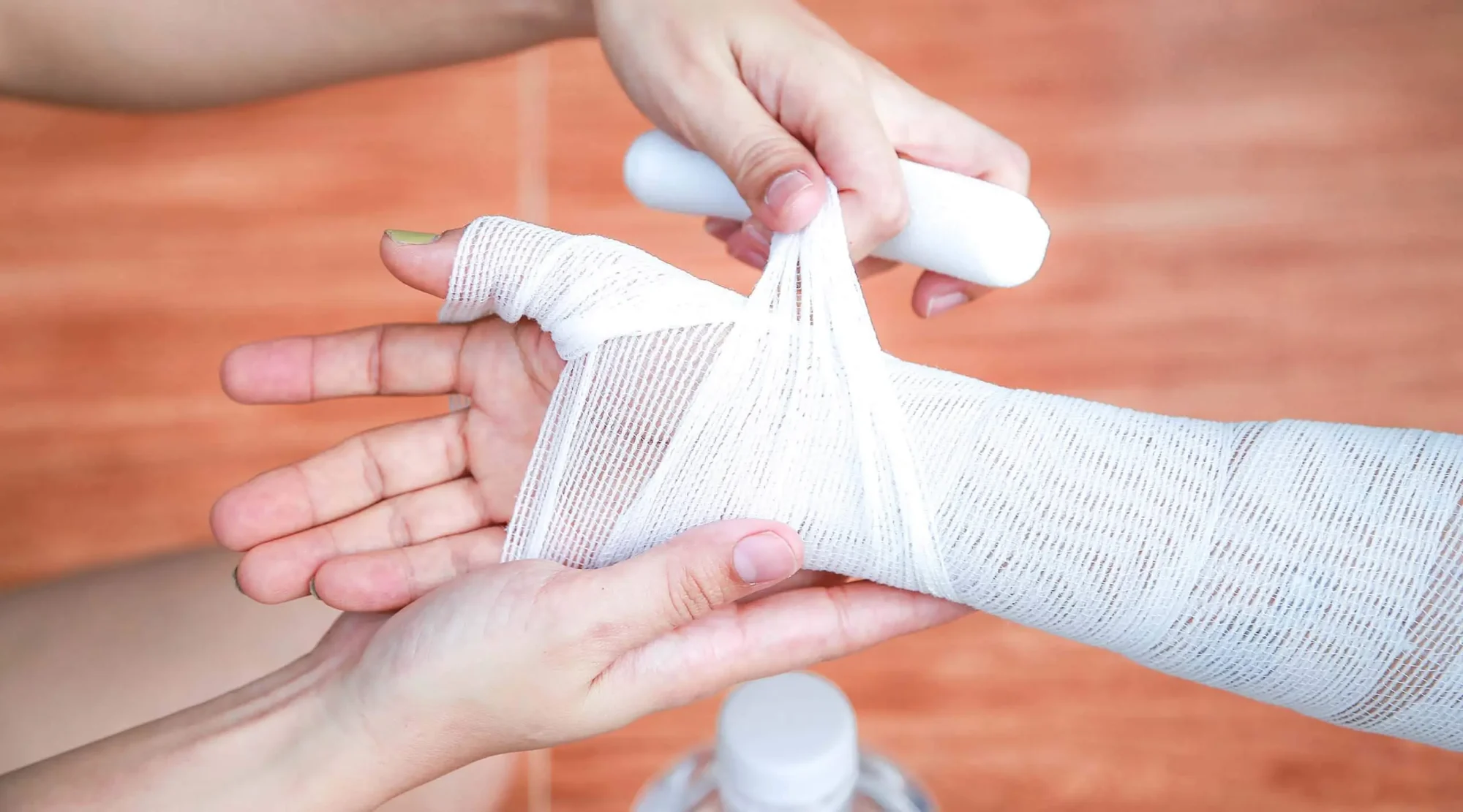 Bandage being wrapped around an injured arm