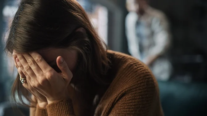 Distressed woman covering her face
