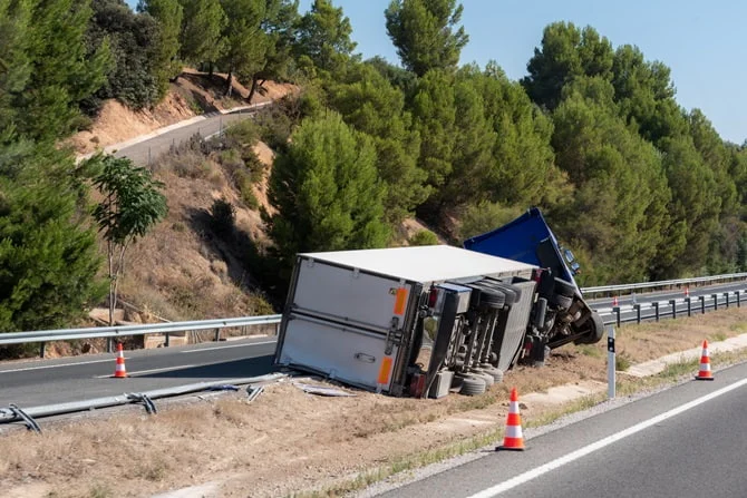 Overturned truck beside a highway