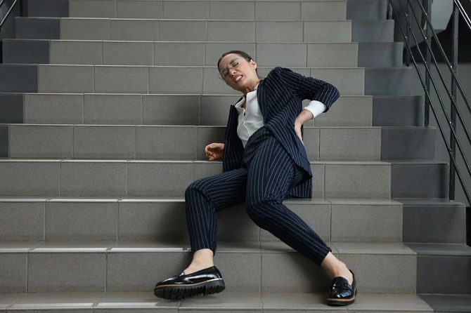 Woman fallen on a staircase