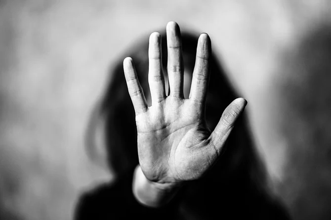 Raised hand in a defensive gesture
