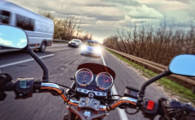 Motorcyclist's view of the handlebars on a highway