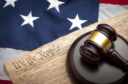 Gavel on the U.S. Constitution with the American flag