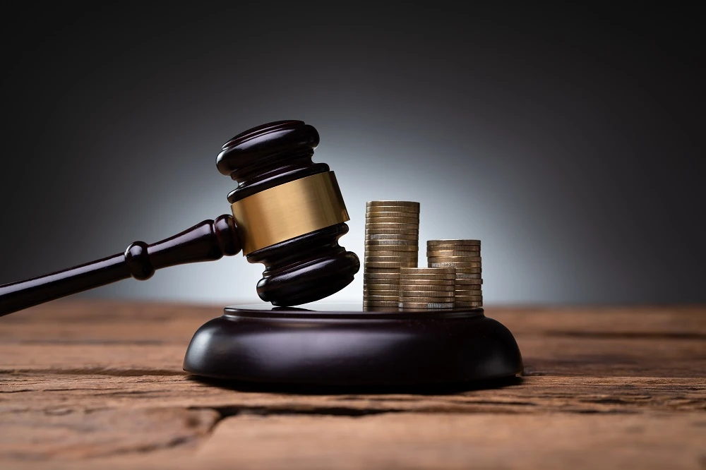 Gavel beside stacks of coins