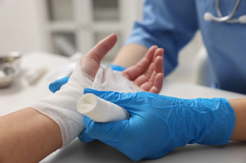 Medic bandaging a patient's burned hand